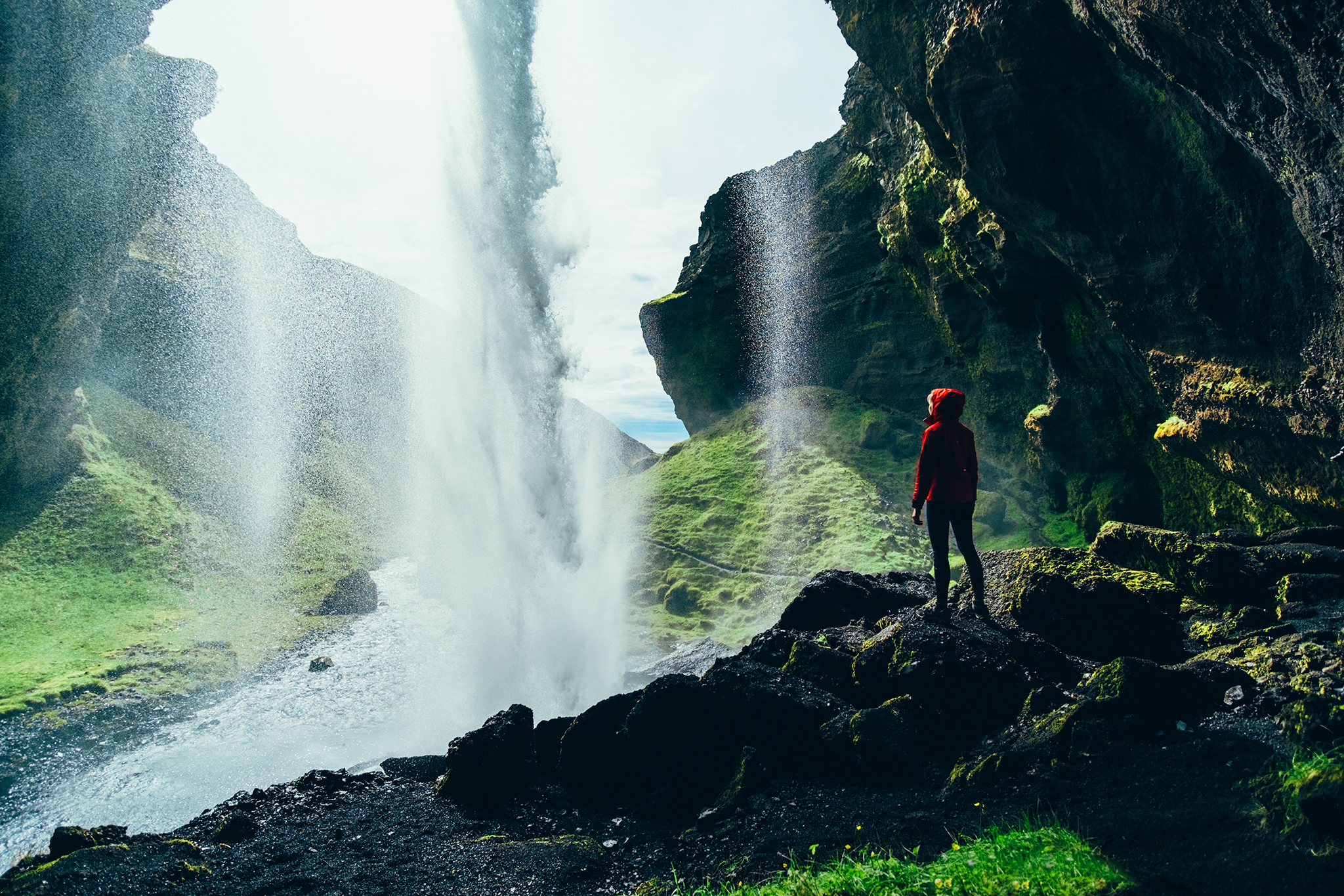 Person standing behind Kvernufoss